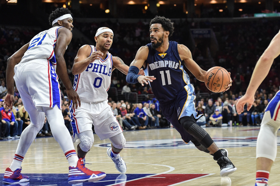 Joel Embiid (21) and Jerryd Bayless (0) defend Mike Conley of the Memphis G...