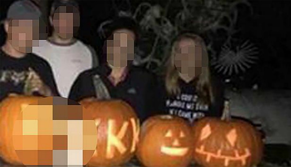 Photo of Coatesville students posing with pumpkins carved with